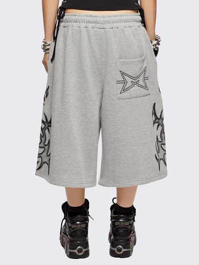 Grey oversized longline sweat shorts with sigilism graphic print.