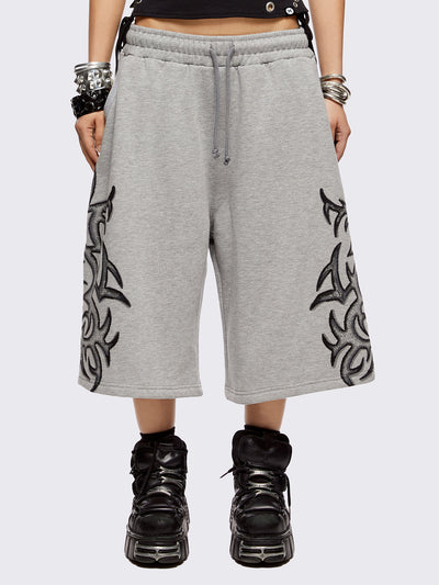Grey oversized longline sweat shorts with sigilism graphic print.