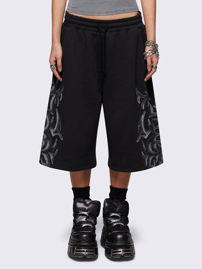 Black oversized longline sweat shorts with sigilism graphic print.