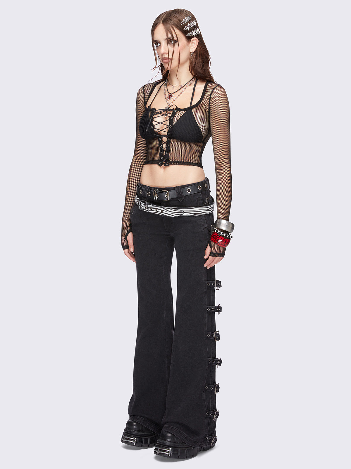 Black fishnet corset top with adjustable lace up front design and thumbhole cuffs.