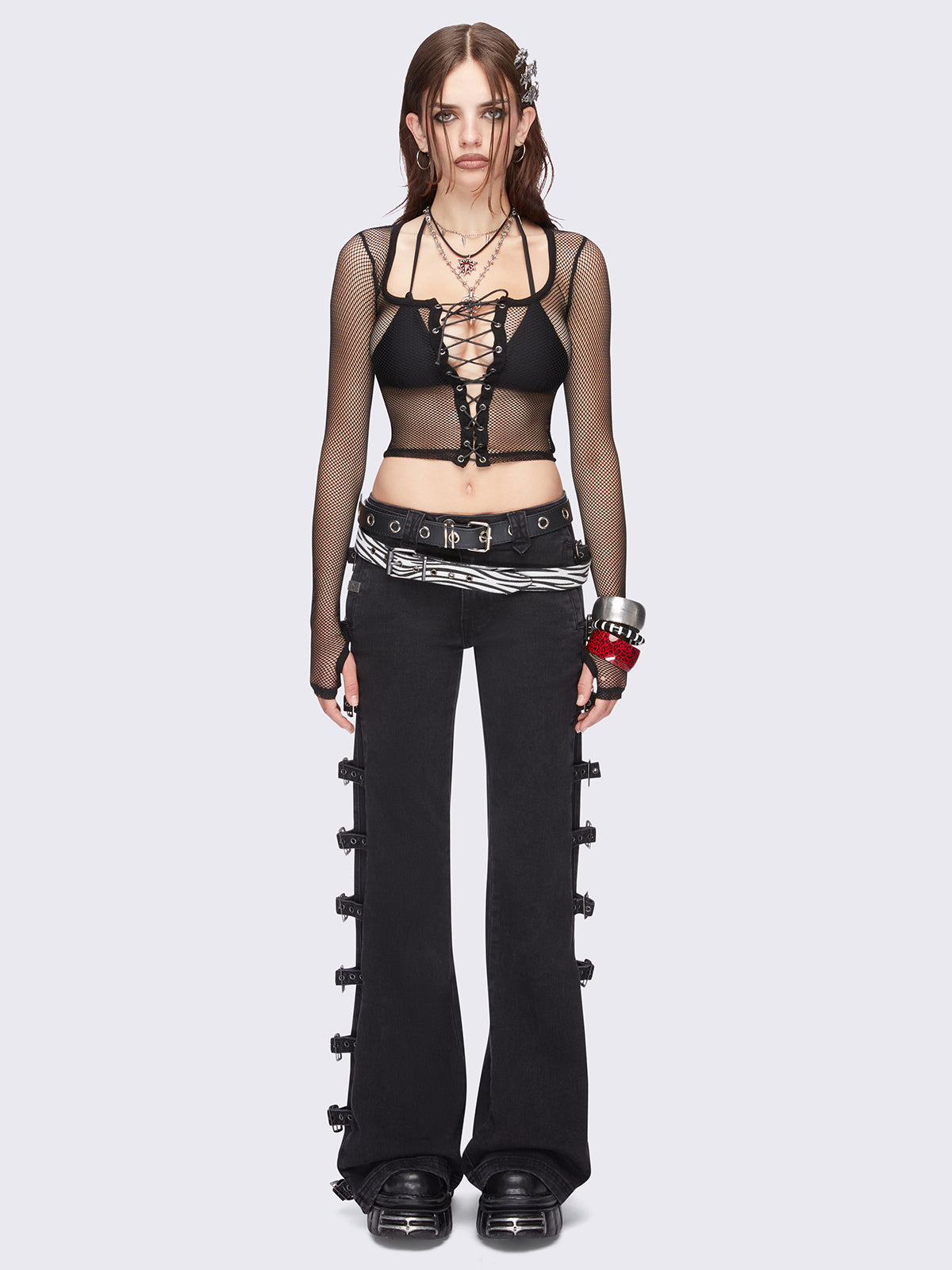 Black fishnet corset top with adjustable lace up front design and thumbhole cuffs.