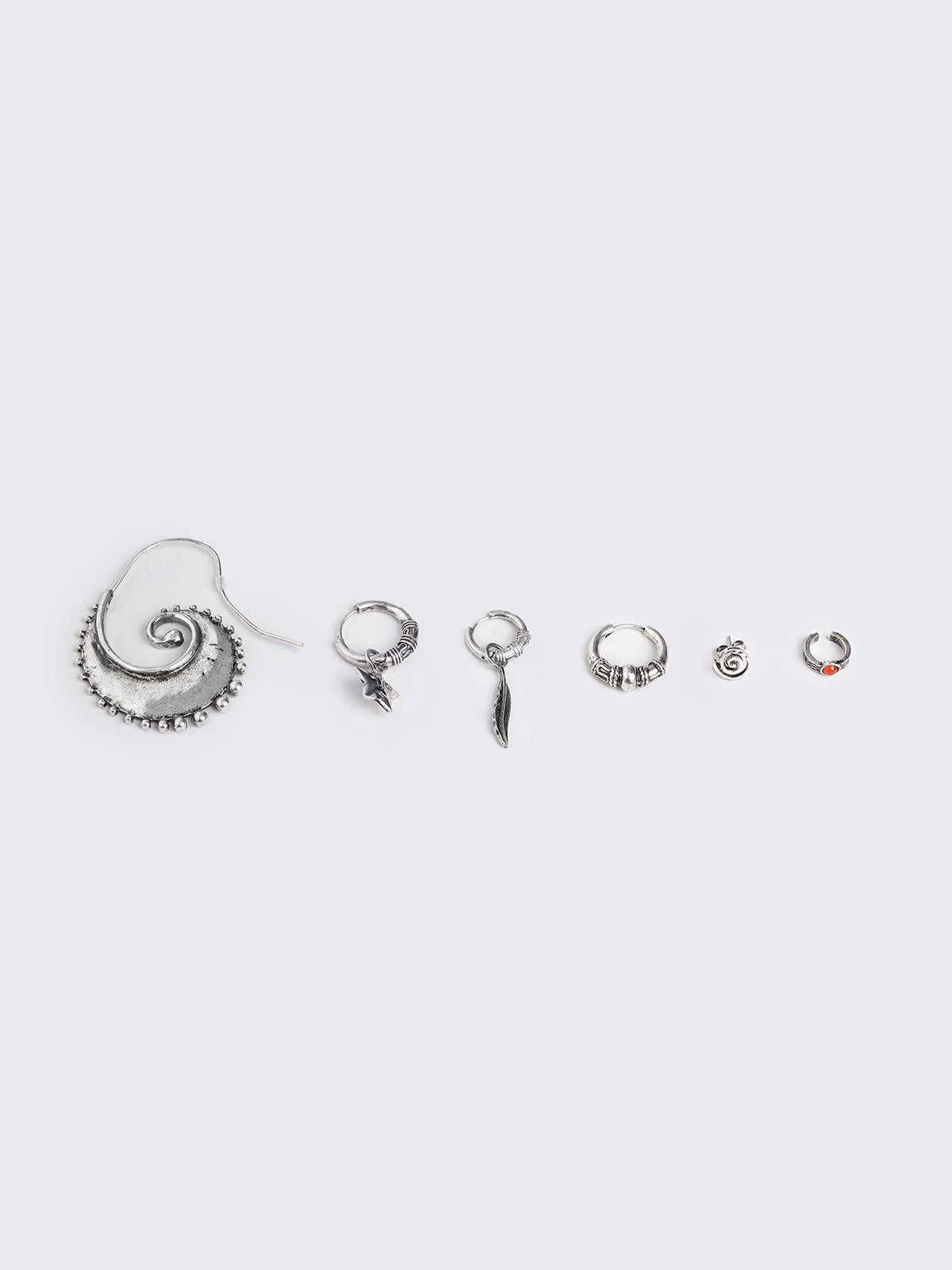 Silver 5-piece earring set including swirl, star, and feather pendants, an ear cuff with a stone accent, and hoop-style earrings.