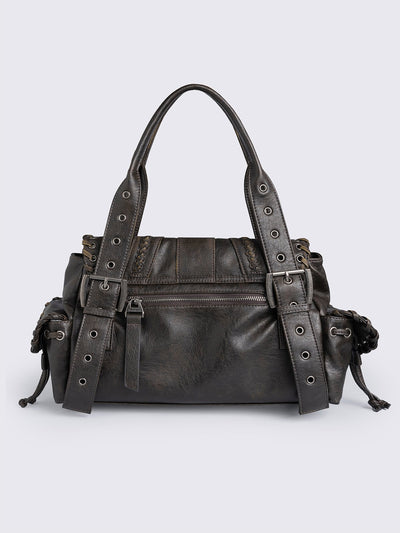 Brown faux leather shoulder bag featuring lace ups, eyelets, buckles and multiple pockets.