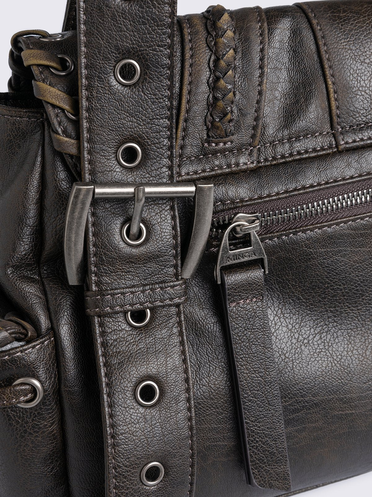 Brown faux leather shoulder bag featuring lace ups, eyelets, buckles and multiple pockets.