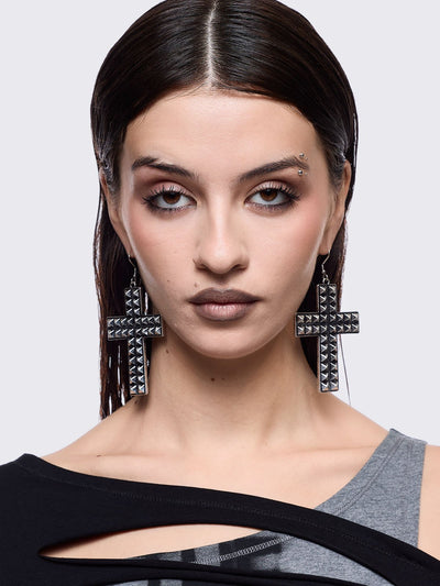 Silver dangle earrings featuring a studded cross design pendants