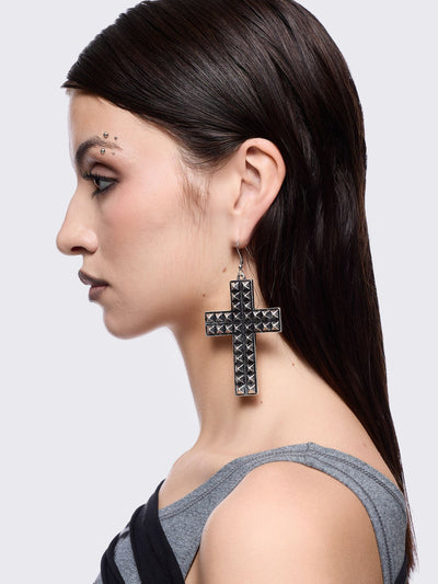 Silver dangle earrings featuring a studded cross design pendants