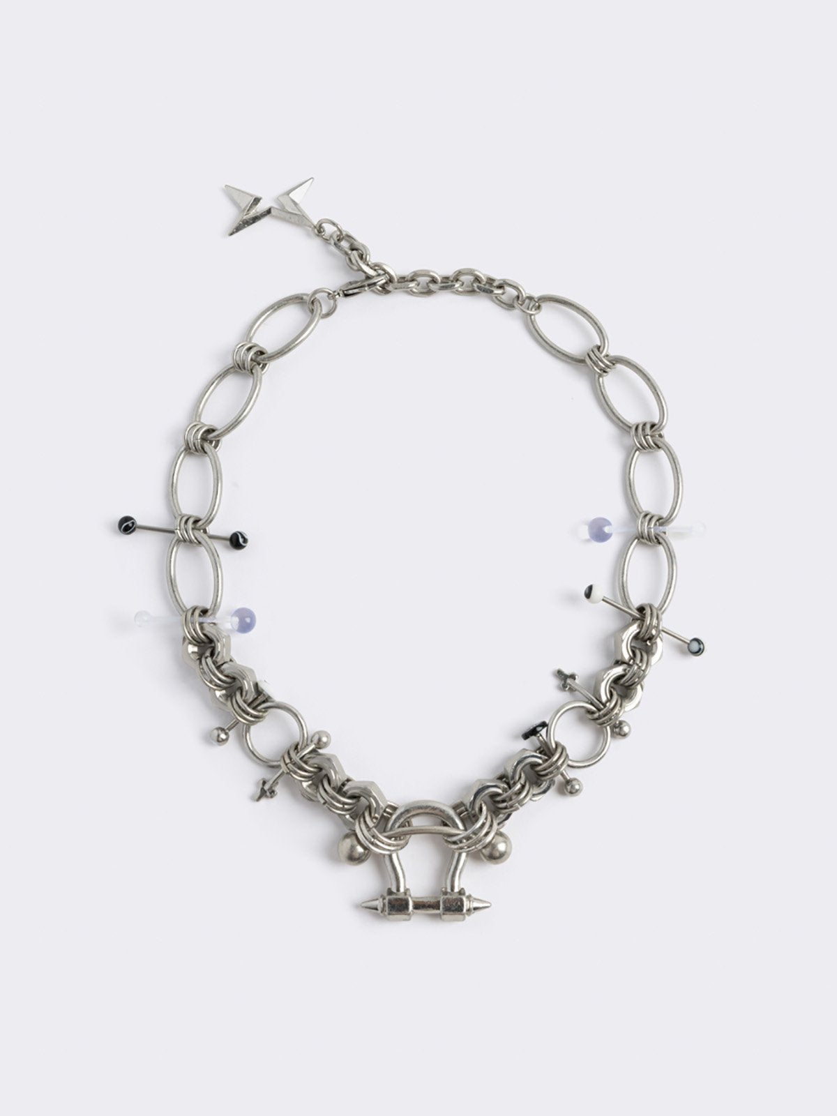 Chunky silver necklace with piercing and industrial details. 