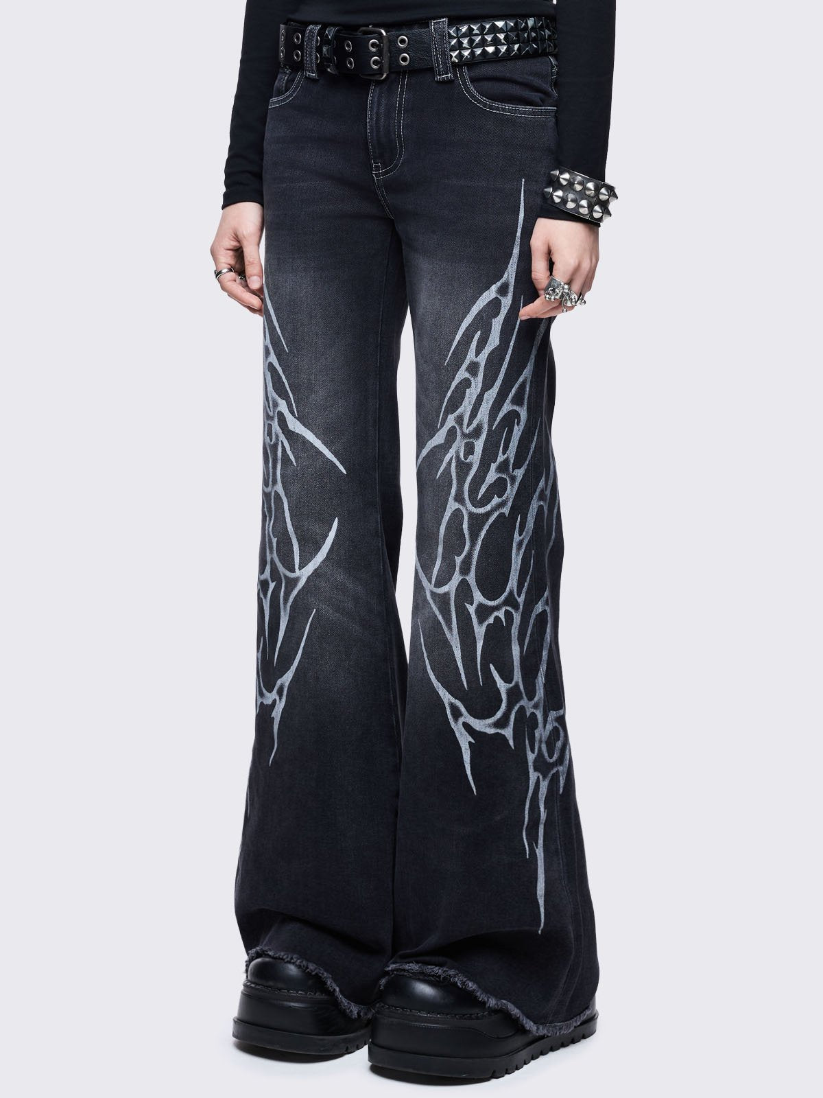 Black washed flared jeans with sigilism side print.