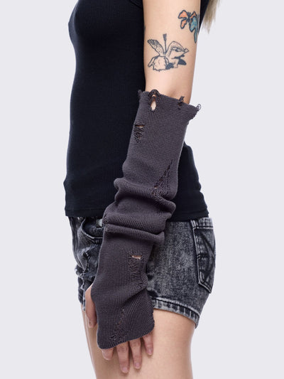 Grey knitted arm warmers with distressed details and thumbhole cuffs