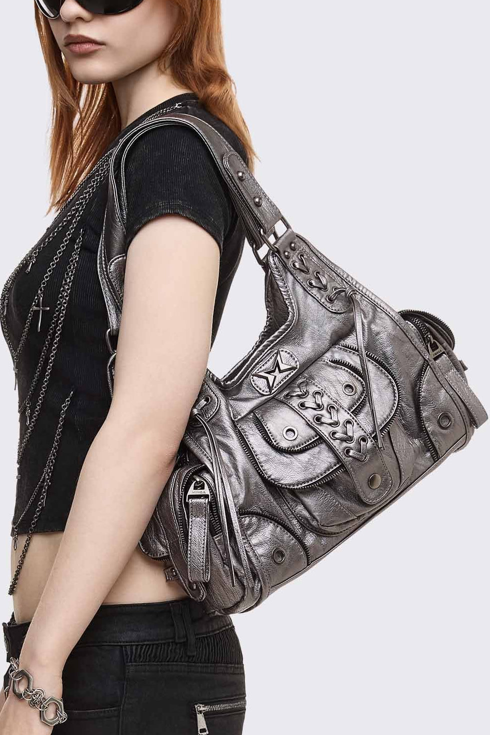 Silver faux leather shoulder bag with lace-up front, zip pockets and antique-silver hardware in a grunge Y2K style.
