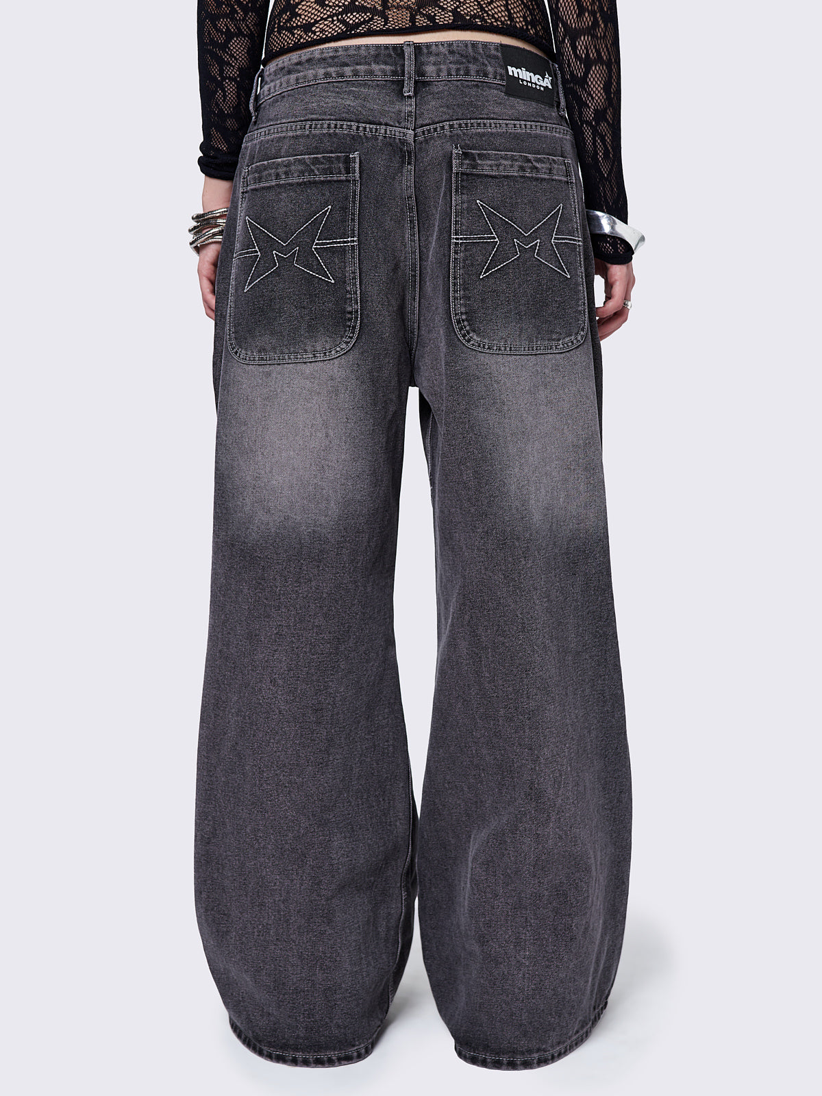 Black washed baggy jeans with grey overdye and cross panels and seams details. 