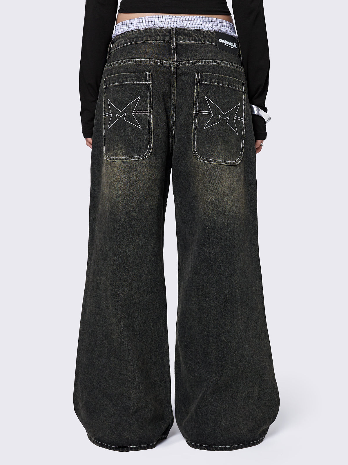 Black washed baggy jeans with green overdye and cross panels and seams details. 