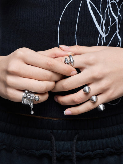 Set of 4 silver rings featuring piercing and spike designs