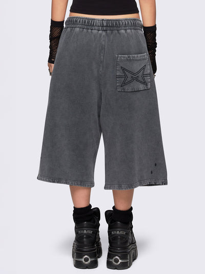 Grey washed longline sweat shorts featuring a distressed details, signature embroidered back pocket detail, elasticated drawstring waist and oversized fit.