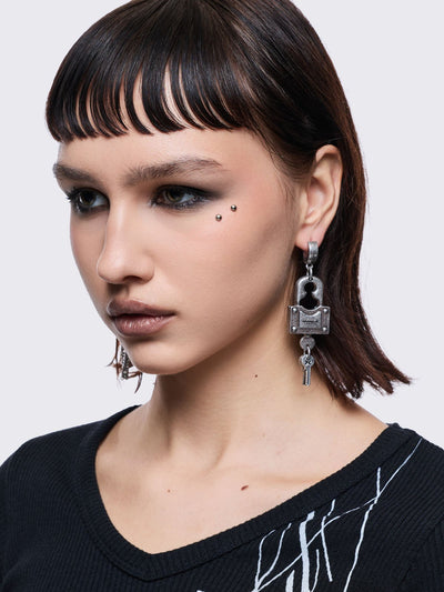 Chunky silver padlock pendant hoop earrings.