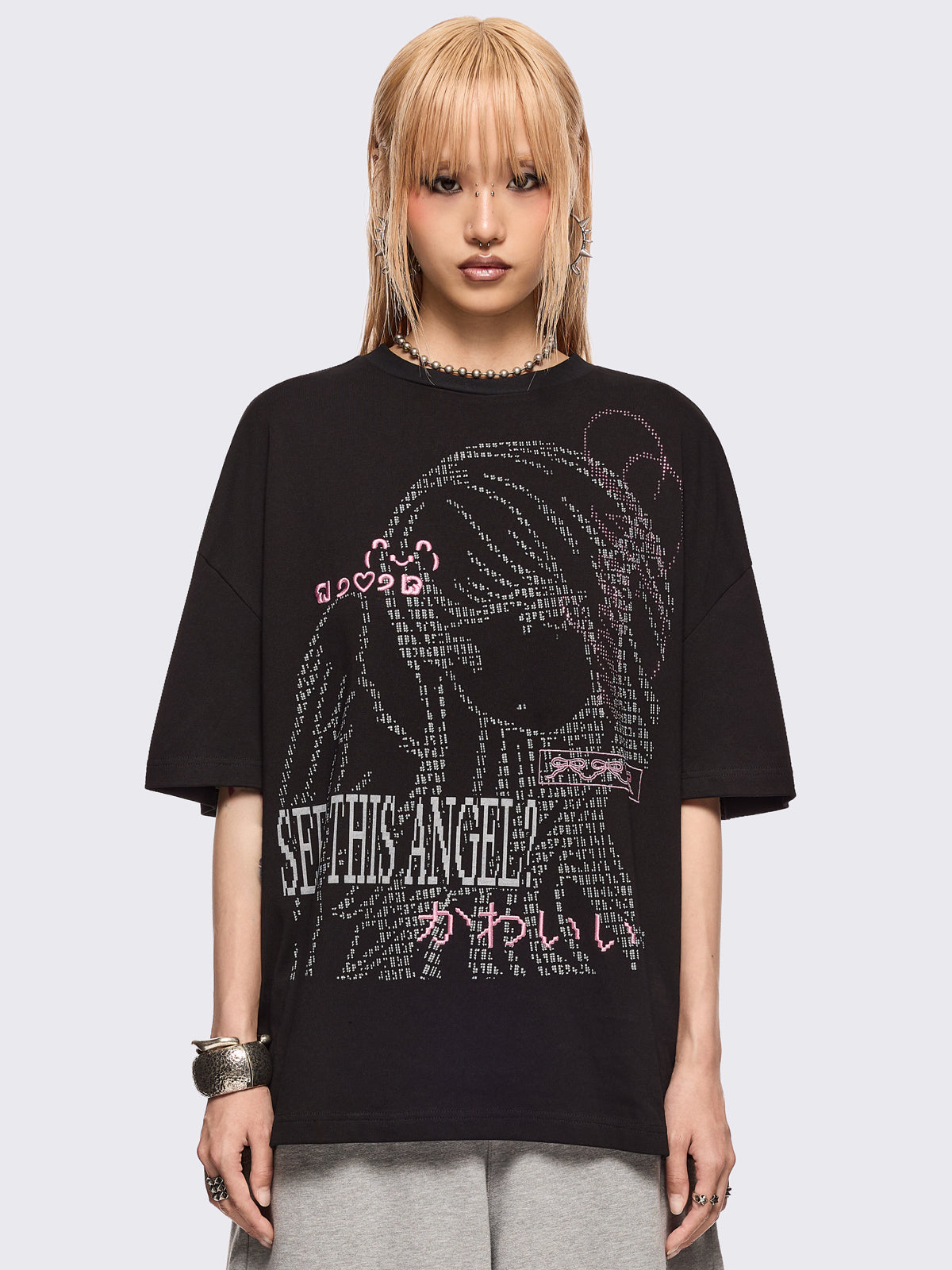 Black oversized t-shirt with "Seen this angel?" and a girl angel graphic print and pink stud and embroidery details.