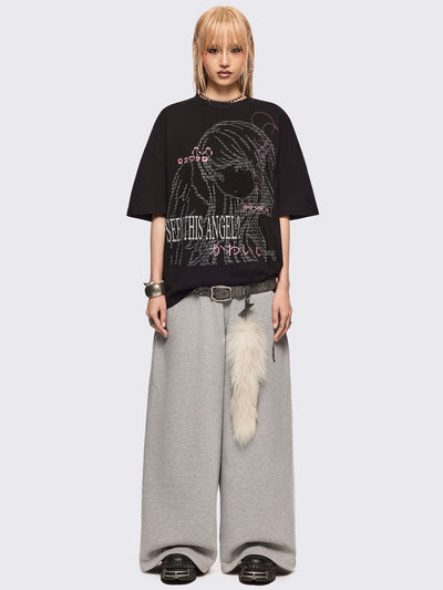 Black oversized t-shirt with "Seen this angel?" and a girl angel graphic print and pink stud and embroidery details.