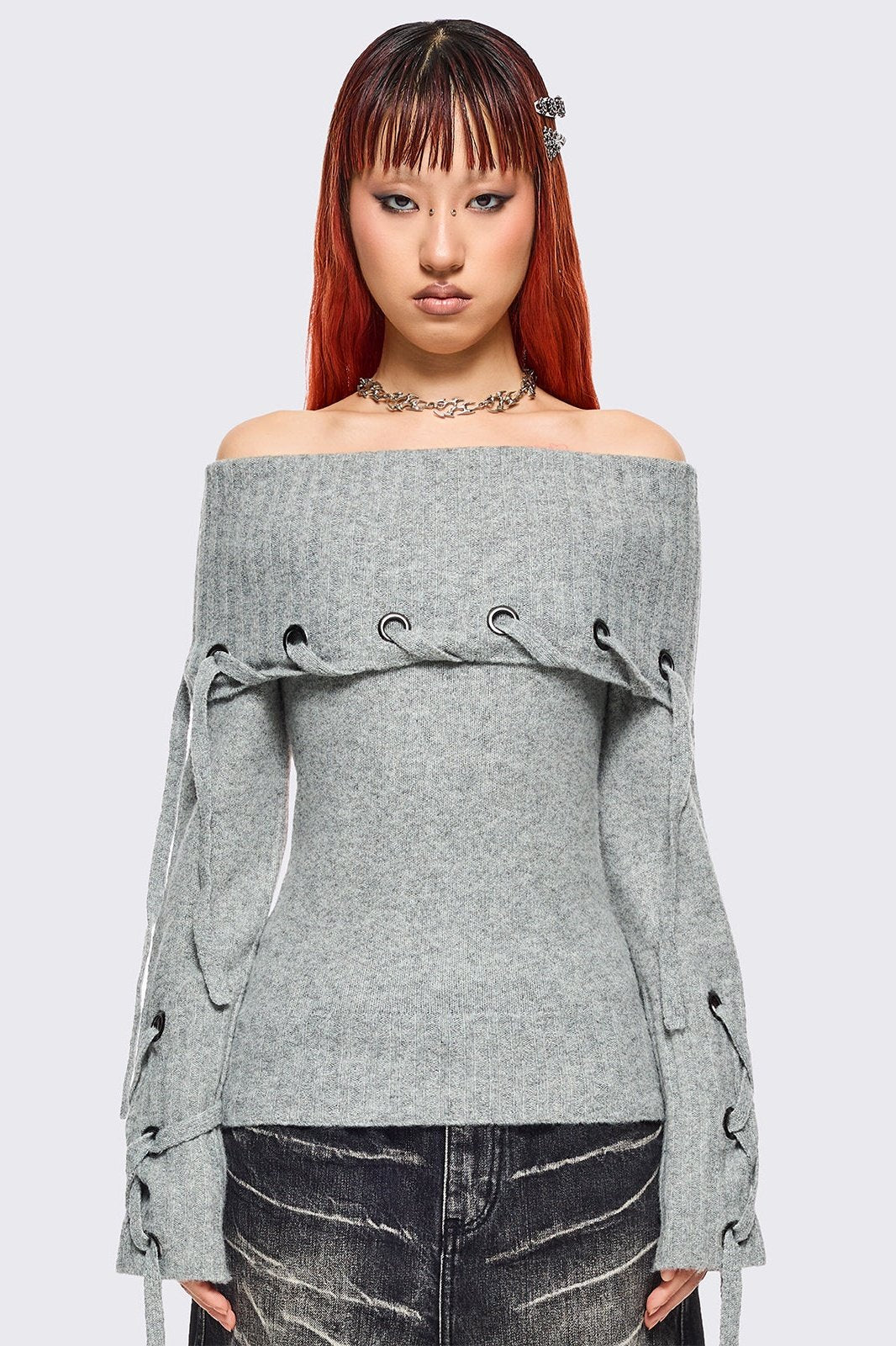 Grey off-shoulder knitted sweater with lace up details.