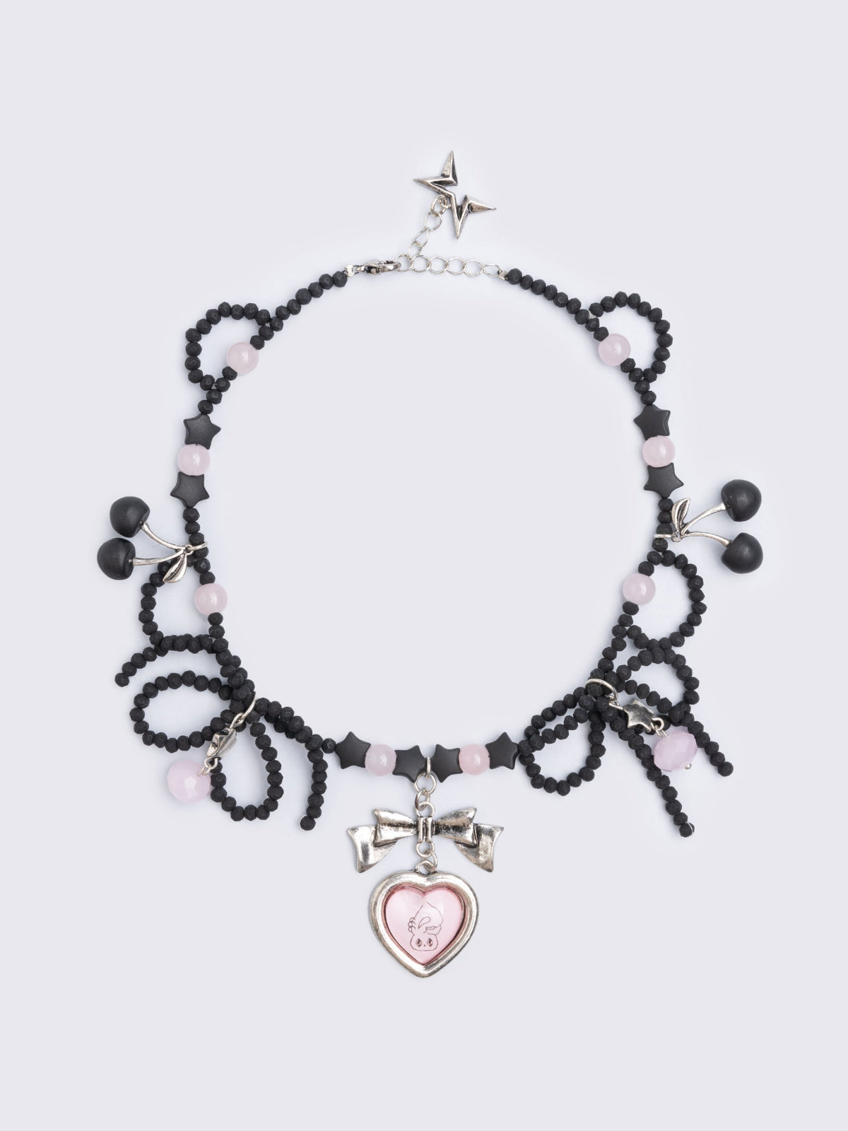 Black beaded necklace with pink heart locket with bunny print by esther bunny artist and back cherry pendants.