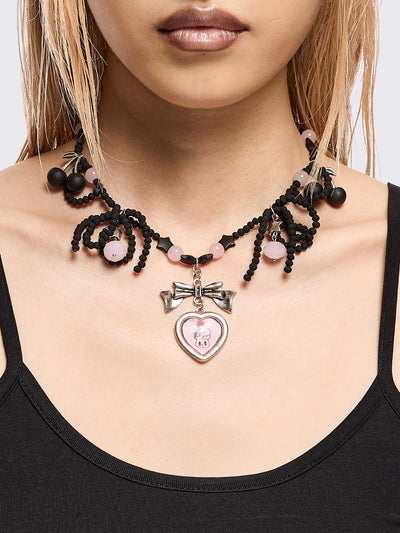 Black beaded necklace with pink heart locket with bunny print by esther bunny artist and back cherry pendants.