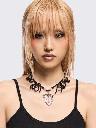 Black beaded necklace with pink heart locket with bunny print by esther bunny artist and back cherry pendants.
