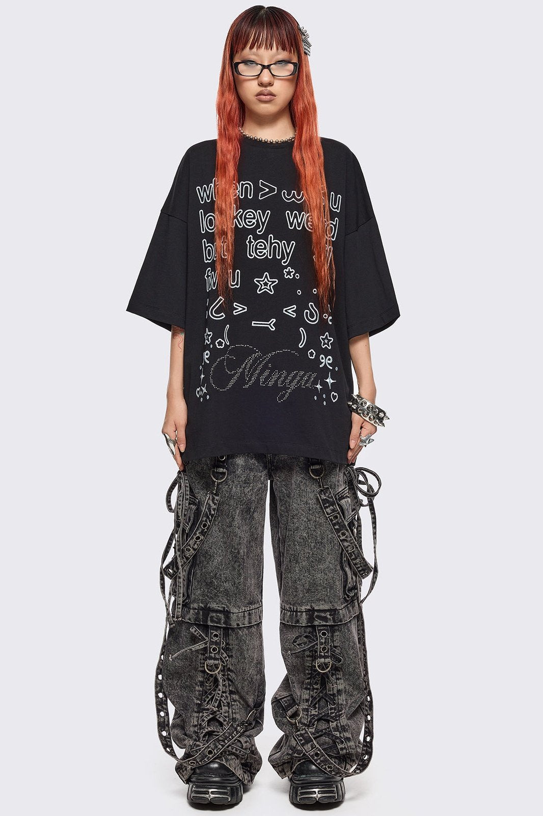 Black oversized t-shirt with "when u lowkey weird but tehy stil fw u" graphic print, kaomoji ASCII-style embroideries and stud details.