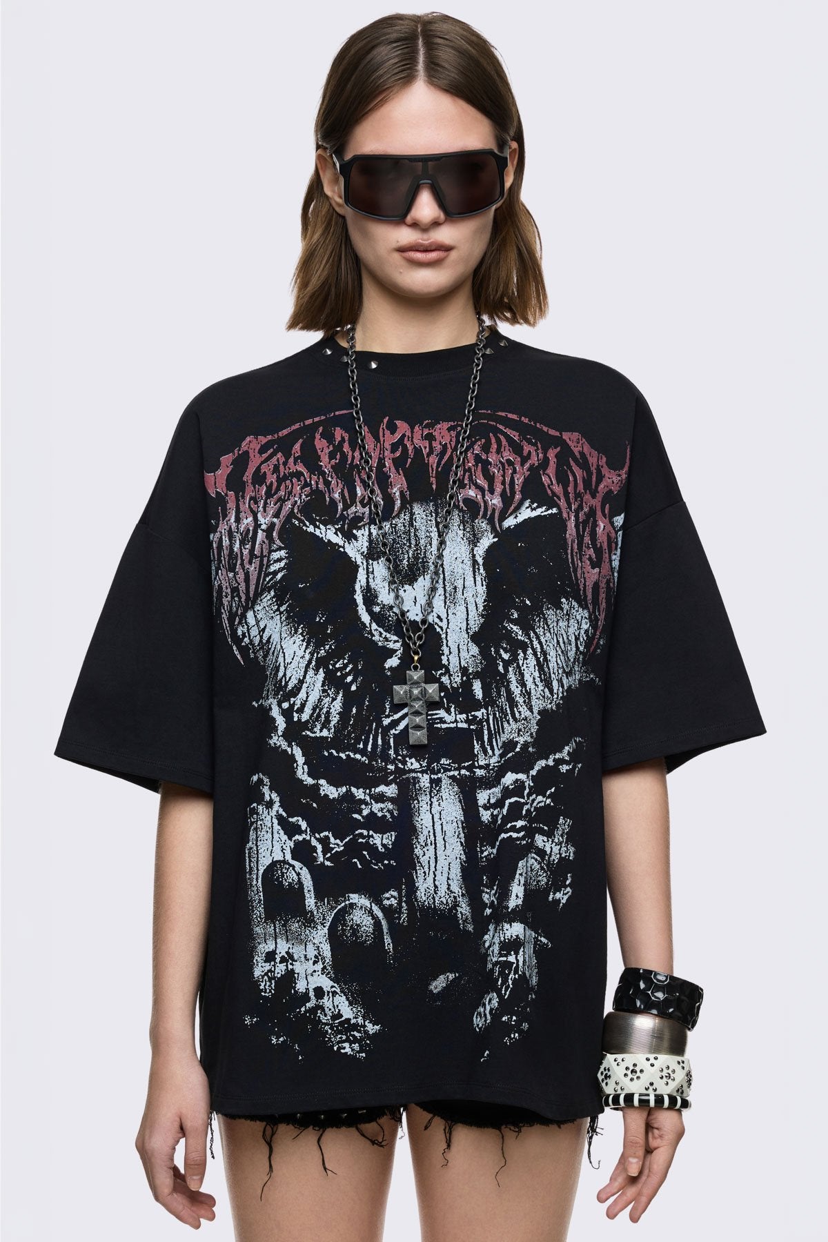 Black cotton T-shirt with dark front graphic print, relaxed fit, and grunge aesthetic.