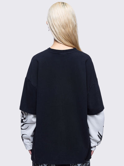 Black washed layered long sleeve t-shirt featuring "Made in hell" and cross graphic print, contrast off-white sleeves with sigilism print and silver eyelet and spike details.