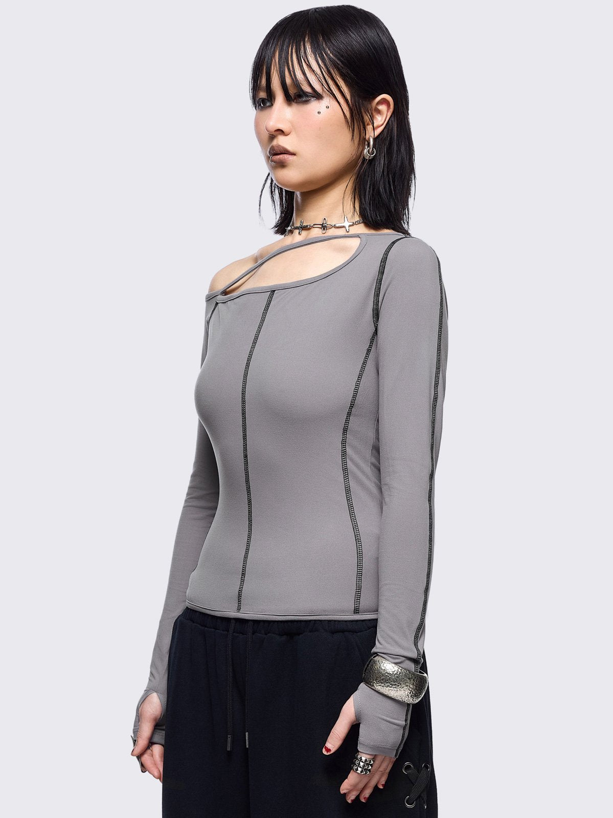 Grey cold shoulder top with cut out details and black contrast stitching.