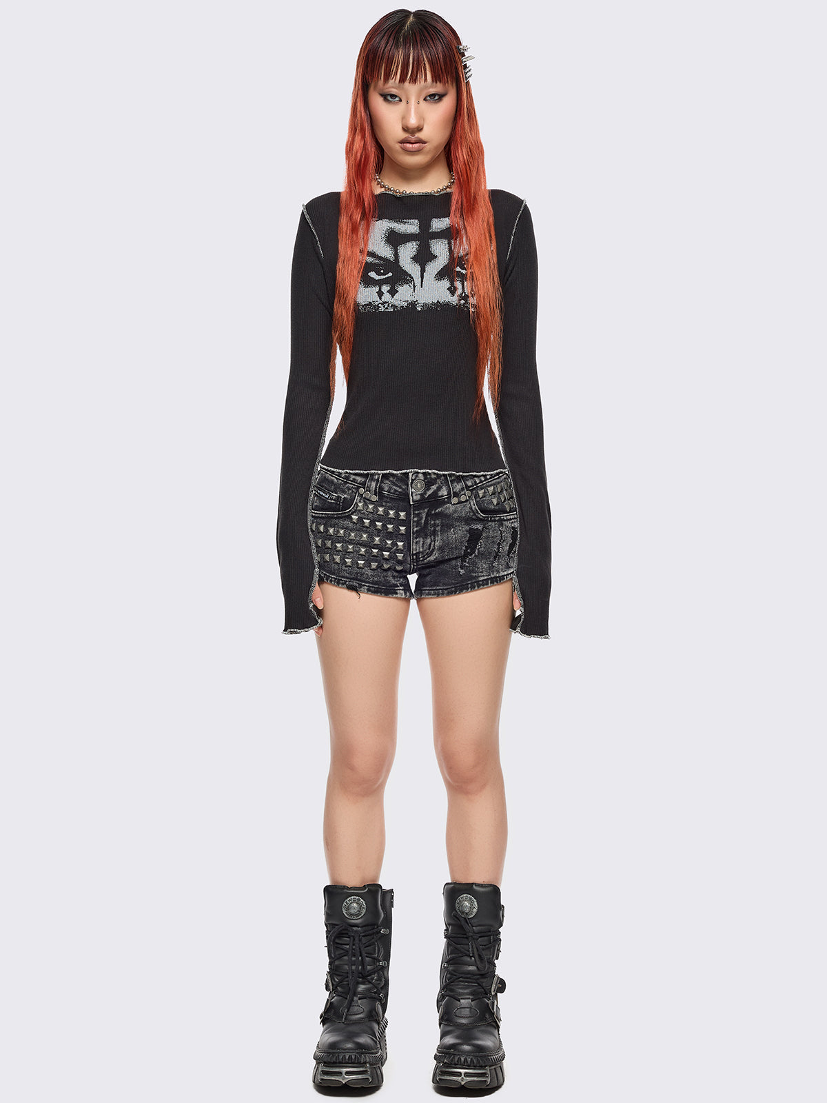 Black ribbed long sleeve top featuring a malefic eyes graphic front print, thumbhole cuffs and white reverse stitching. 
