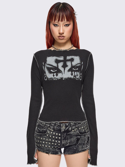 Black ribbed long sleeve top featuring a malefic eyes graphic front print, thumbhole cuffs and white reverse stitching. 