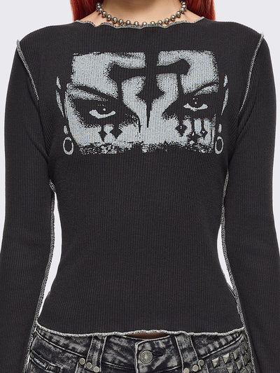 Black ribbed long sleeve top featuring a malefic eyes graphic front print, thumbhole cuffs and white reverse stitching. 