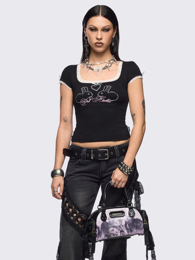 Black and pink bowling bag with kittens graphic print, rhinestone details and side exterior pockets with lace up bows.