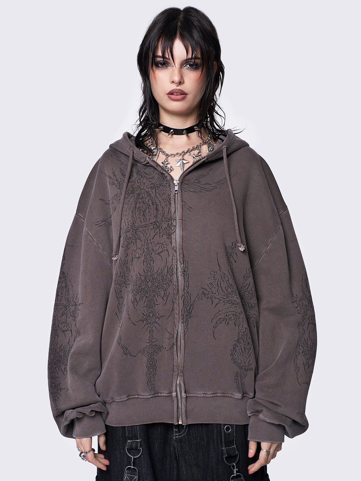 Washed brown zip-up hoodie jacket with grunge graphic prints on the front and sleeves.