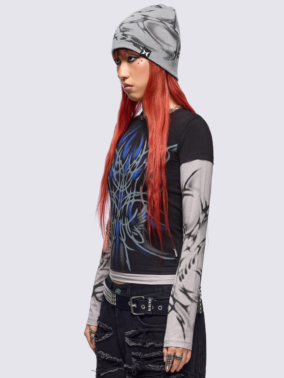 Black layered long sleeve top with grey contrast sleeves featuring a graphic print by cold𝐹33t designer.