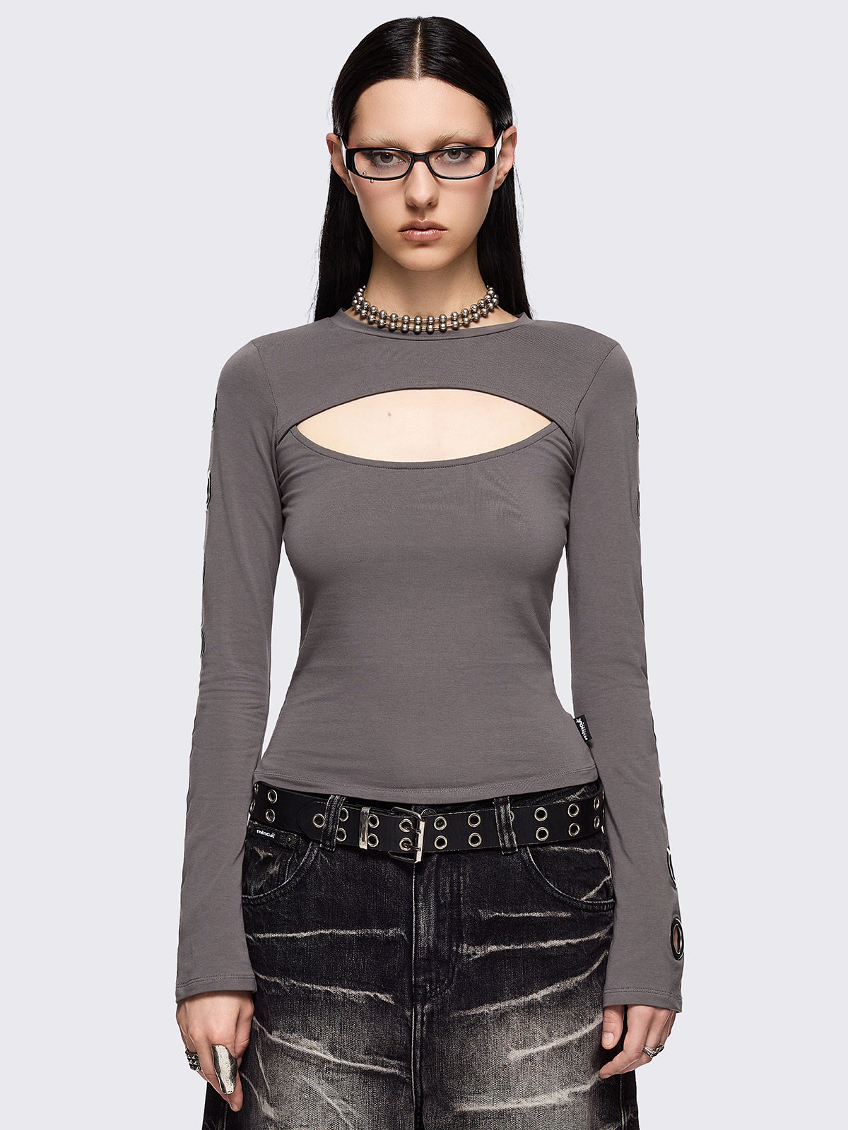 Grey cut-out long sleeve top with chunky silver eyelets on sleeves.