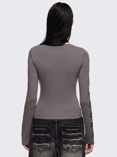 Grey cut-out long sleeve top with chunky silver eyelets on sleeves.