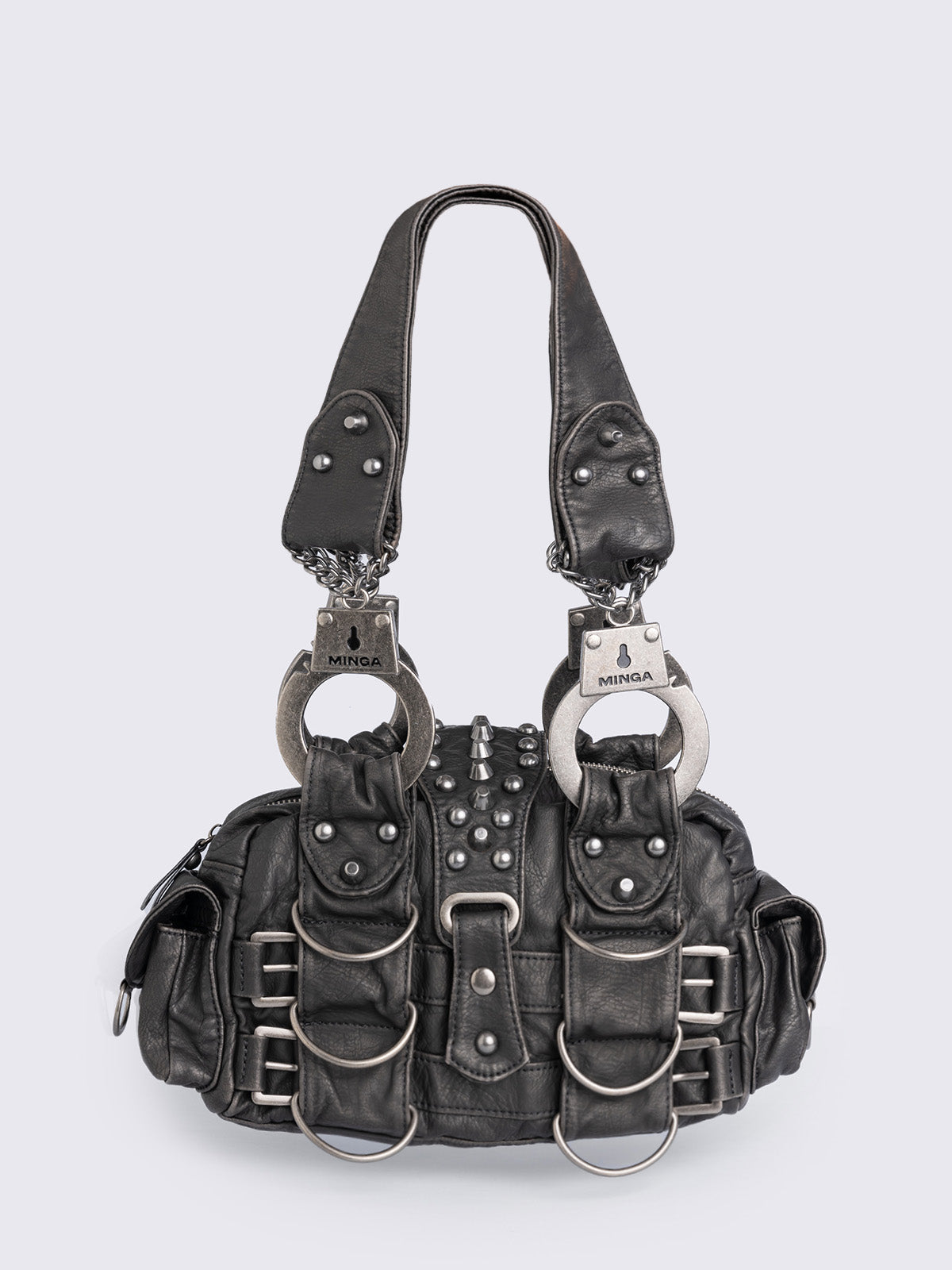 Black vegan leather shoulder bag with handcuffs handles, D-ring, buckle and stud details. Multiple pockets and zip top closure.