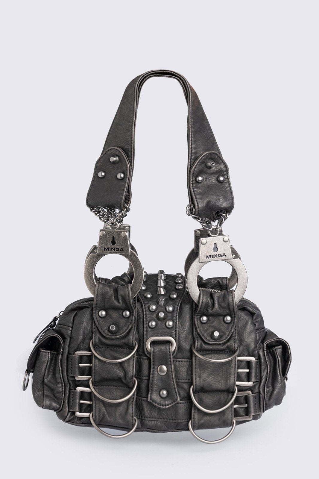 Black vegan leather shoulder bag with handcuffs handles, D-ring, buckle and stud details. Multiple pockets and zip top closure.