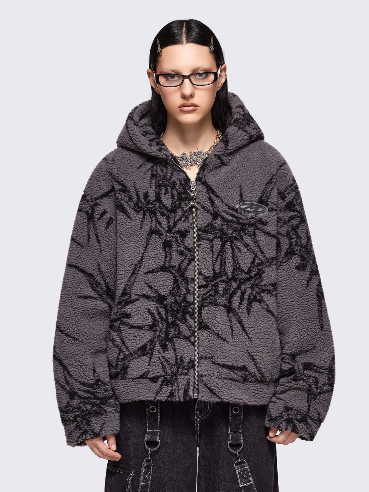 Grey fleece hoodie jacket featuring all over black thorns design.