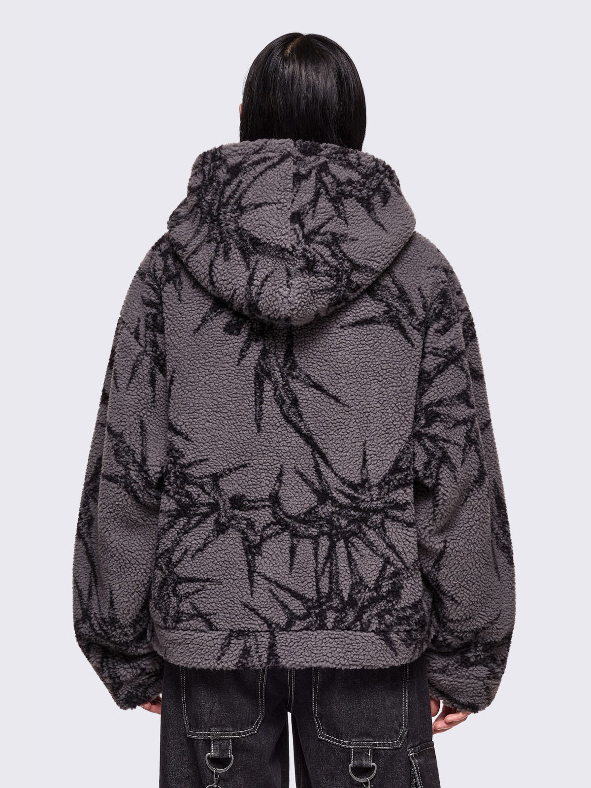 Grey fleece hoodie jacket featuring all over black thorns design.
