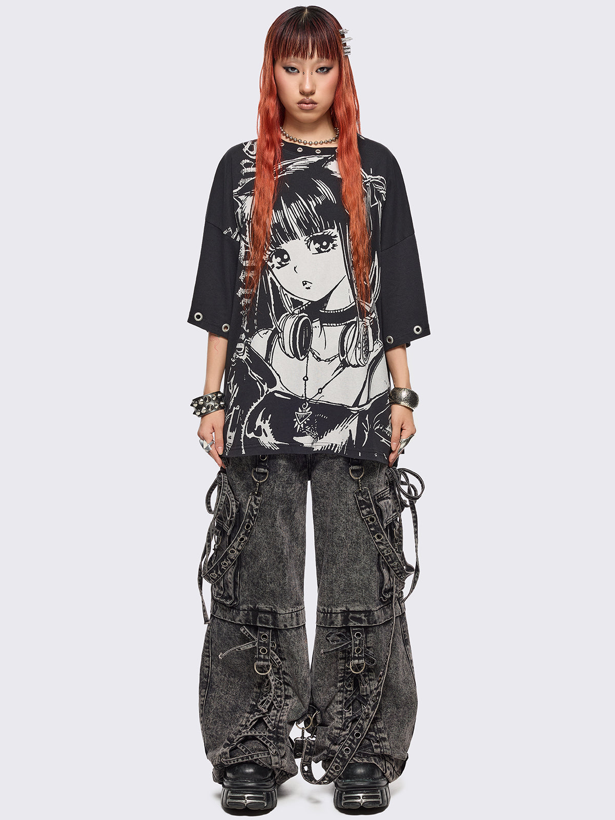 Black oversized t-shirt with anime girl graphic front print and silver eyelets trims.
