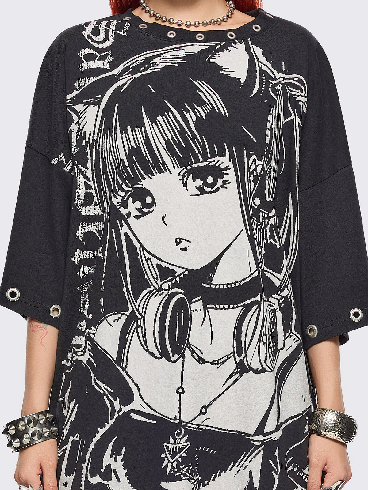 Black oversized t-shirt with anime girl graphic front print and silver eyelets trims.