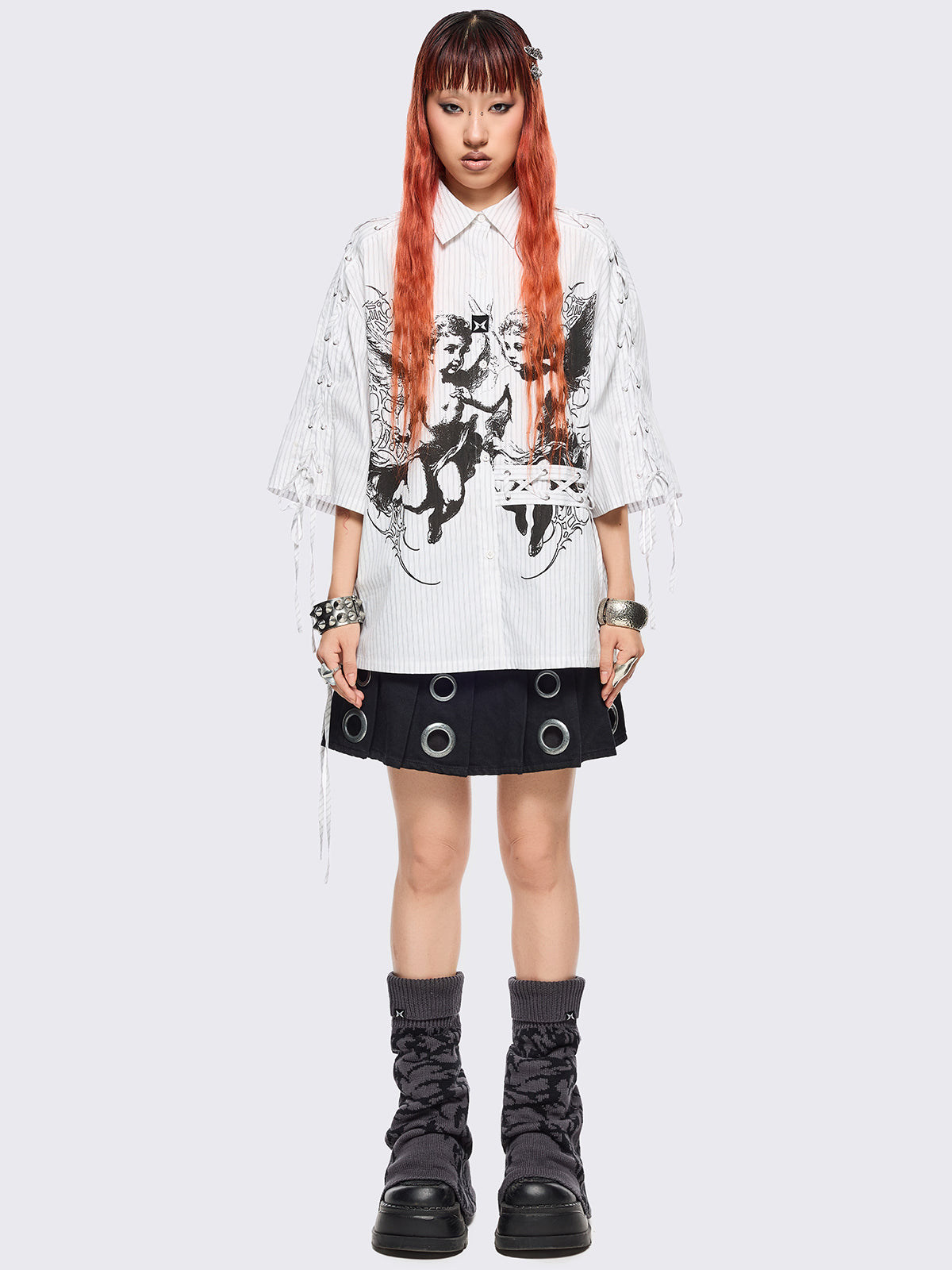 Grey flared leg warmers with black sigilism graphic design.
