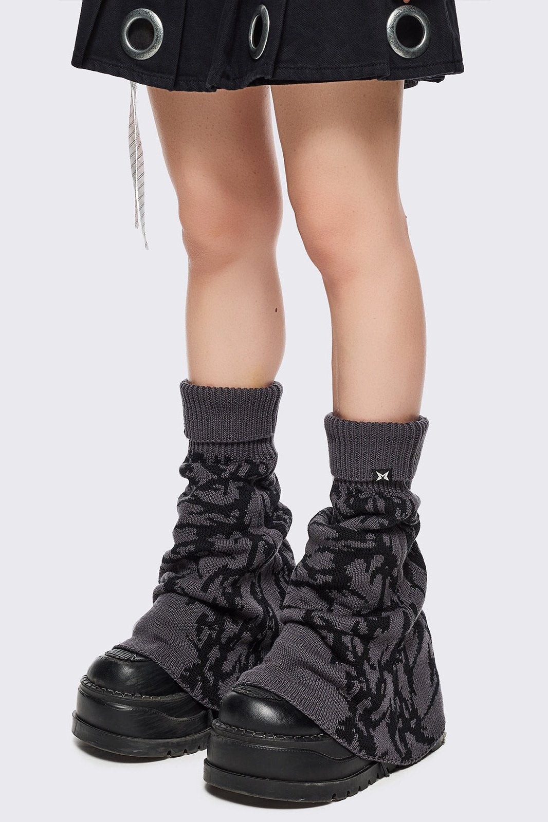Grey flared leg warmers with black sigilism graphic design.