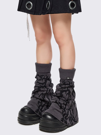 Grey flared leg warmers with black sigilism graphic design.