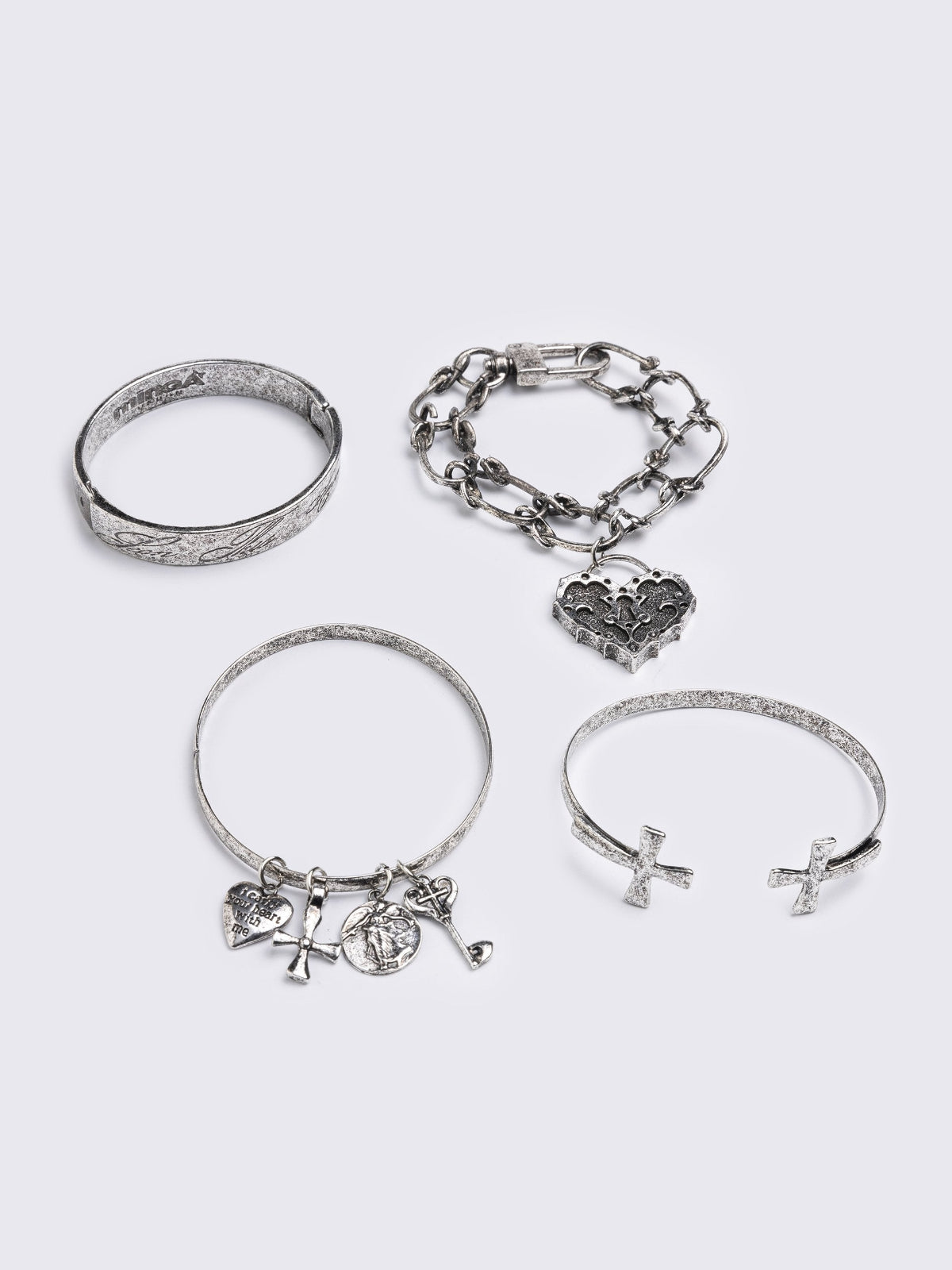 Set of 4 bracelets with cross design and heart pendants