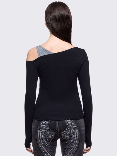 Black and grey long sleeve layered cold shoulder top featuring a front cut-out slash details and a grunge graphic print. 