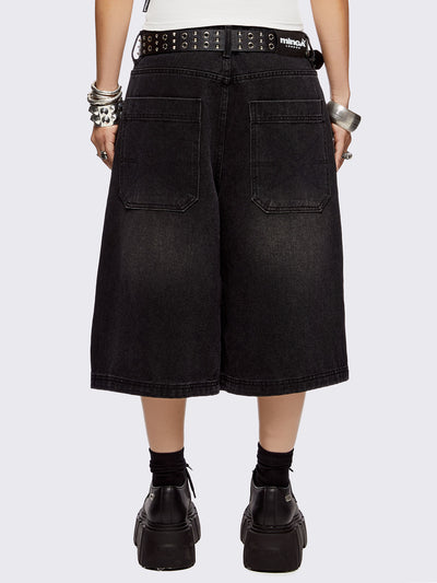 Black washed longline denim shorts with eyelets, chains, safety pins and more metal hardware details. Streetwear, grunge and y2k vibes.