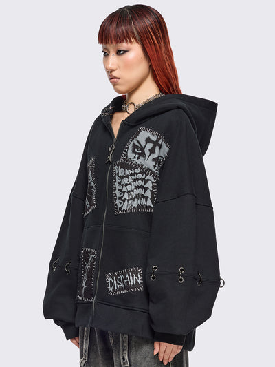 Black zip up hoodie jacket with white grunge print patches and eyelets with O-ring and piercing details.